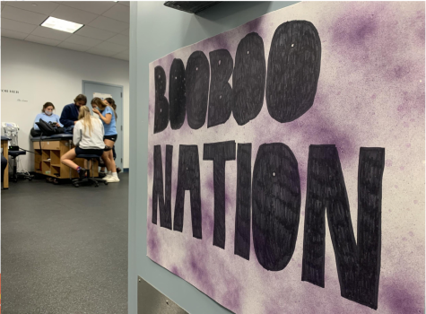A poster reading “Boo-Boo Nation” hangs on the door to Athletic Trainer Ms. Belinda Rodriguez‘s office. The poster was made to hang in the gym during last year’s senior volleyball game and was given as a gift to Ms.Rodriguez from the seniors after the game. “I used to play volleyball myself in high school, so the game will always have a special place in my heart,” Ms. Rodriguez said.
 