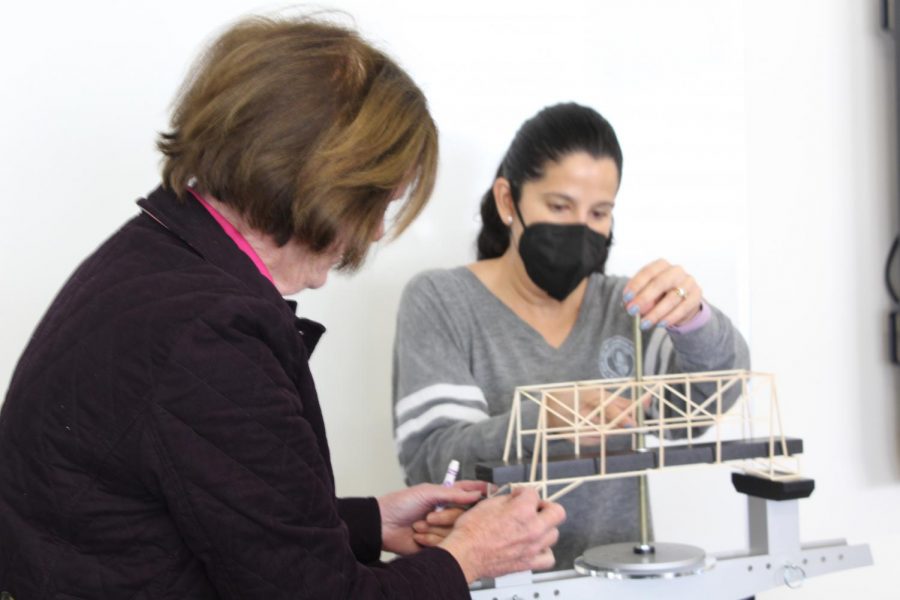 Physics teacher Sister Janice Shaw and STEM teacher Mrs. Rovirosa testing students bridges in A3 STEM. It was a hands on experience. Difficult, yet was rewarding to see it put together, senior Jessica DaSilva said.