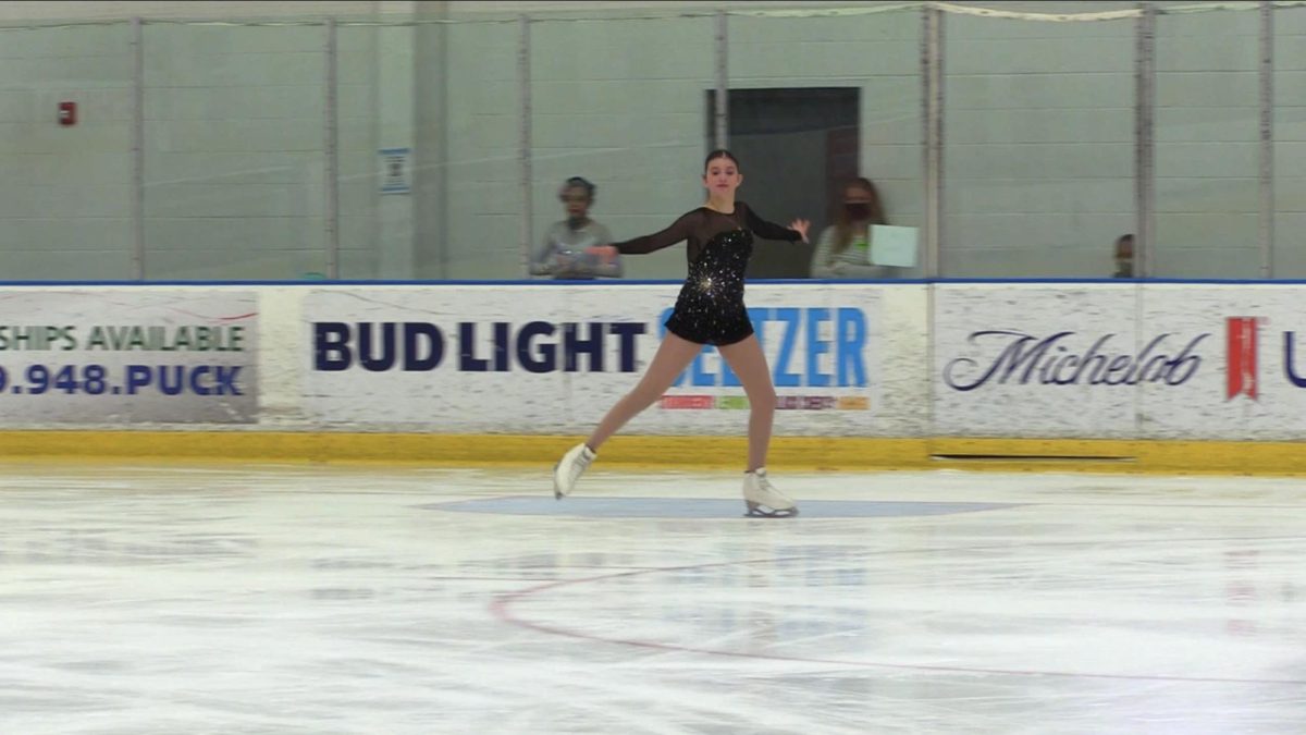 Senior Emma Cheney in the middle of her set performing at one of her many figure skating competitions.