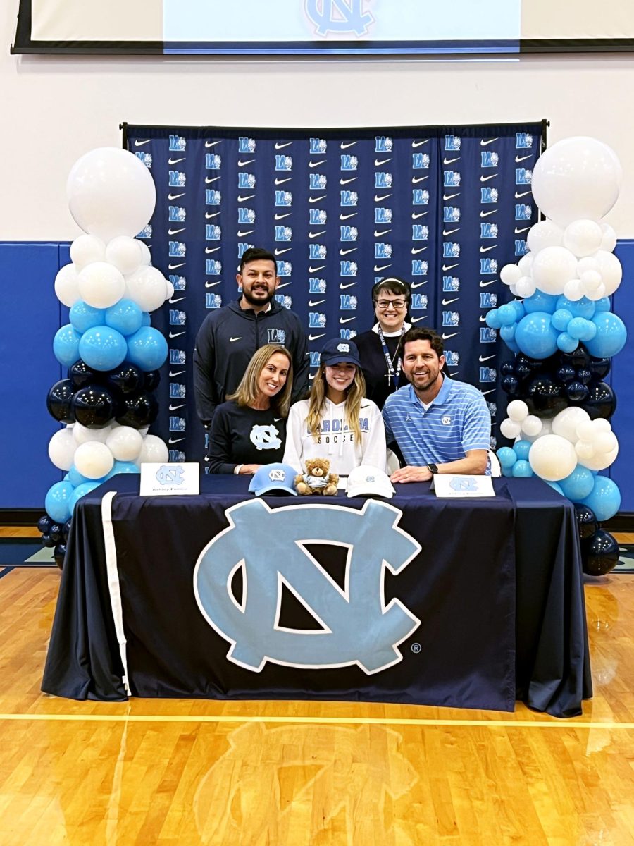 Ashley Pennie officially committing to play soccer at UNC Chapel Hill, surrounded by her friends and family.