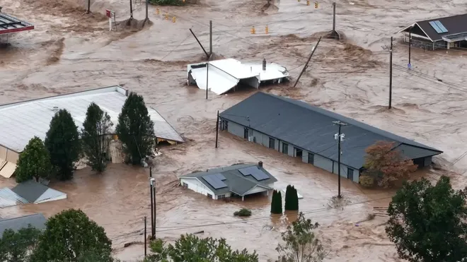 A home in Black Mountain, North Carolina is pictured submerged beneath the flood. (Photo courtesy of USA Today)