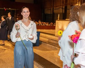 Junior Carolina Lopez receiving her junior ring and celebratory flower.