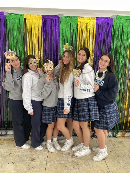 A group of sisters taking pictures together and enjoying having fun with their little sisters.