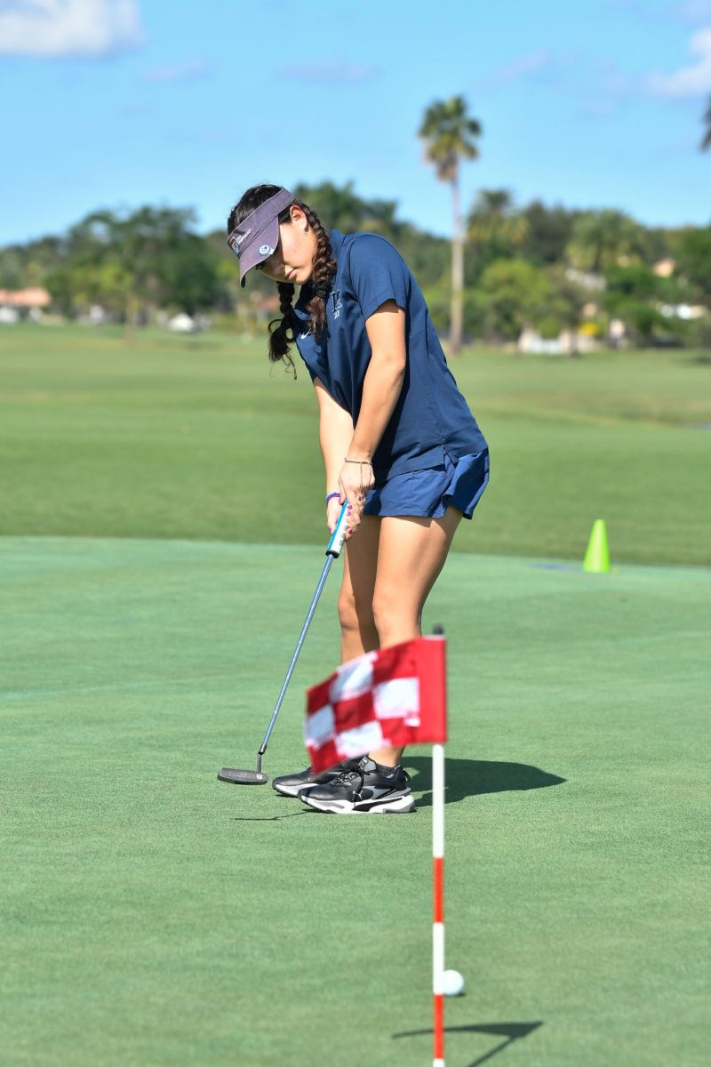 Senior golfer Gaby Barcia follows through on her drive during the regionals match.