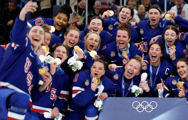 The United States women's hockey team pose for a team group photo with their gold medals. Image courtesy of: REUTERS/David W Cerny