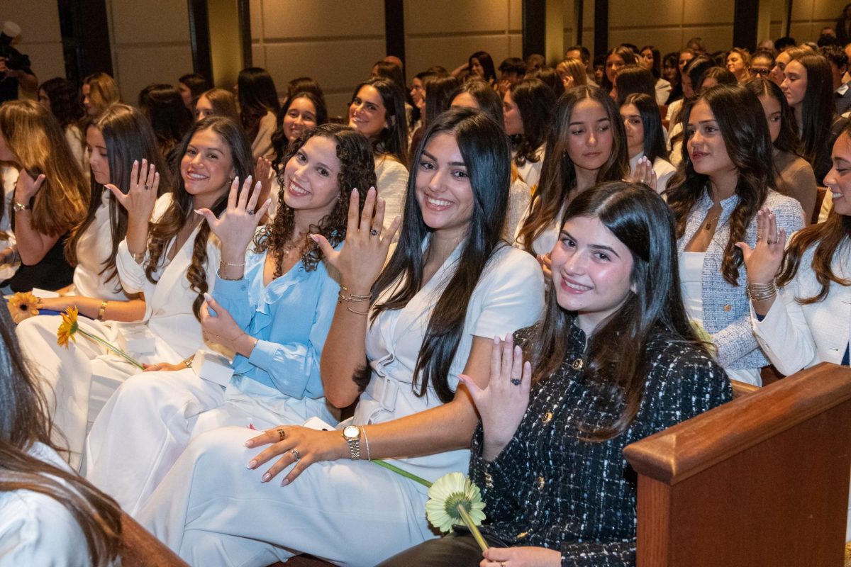 Members of the Class of 2027 proudly showing off their new bling that connects them with generations of Lourdes girls and women.